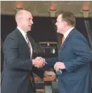  ??  ?? Illinois athletic director Josh Whitman ( left) shakes hands with new basketball coach Brad Underwood at a news conference Monday in Champaign.
