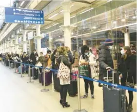  ?? STEFANROUS­SEAU/PA ?? Peoplewait to board the last train to Paris on Sunday at the St Pancras railway station in London. Several nations in the EUopted to ban travel fromtheU.K. amid a surge of cases resulting froma more virulent coronaviru­s strain.