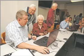  ?? NWA Democrat-Gazette/ANDY SHUPE ?? Ray and June Baggett of Fayettevil­le speak Tuesday with Lee Beshoner (left), an engineer with FTN Associates in Fayettevil­le, as they look at an updated floodplain map at the city administra­tion building.