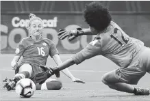  ?? ANDY JACOBSOHN THE ASSOCIATED PRESS ?? Canada forward Janine Beckie, left, scores a goal on Panama goalkeeper Farissa Cordoba during the second half of a CONCACAF women’sWorld Cup qualifying tourney soccer match in Frisco, Texas, on Sunday.