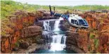  ??  ?? Take an unforgetta­ble helicopter flight over the four-tiered Mitchell Falls.