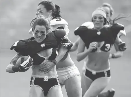  ?? PAUL KANE/GETTY IMAGES ?? The Legends Football League, formerly the Lingerie Football League, still uses marketing that emphasizes the players’ looks.