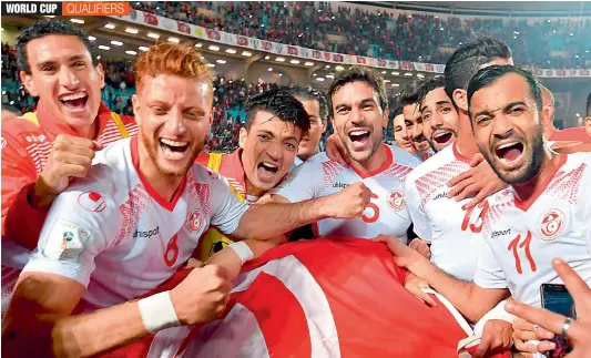  ?? — AFP ?? Tunisian players celebrate after qualifying for the 2018 Fifa World Cup finals after beating Libya at the Rades Olympic Stadium in the capital Tunis on Saturday.