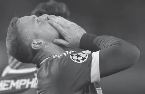  ?? JOHN THYS/AFP/GETTY IMAGES ?? Manchester United’s Wayne Rooney celebrates scoring the first of three goals against Club Brugge on Wednesday. United won 4-0.