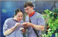  ?? PROVIDED TO CHINA DAILY ?? A couple get fully occupied with a cryptic piece of paper in an escape room competitio­n in Shijiazhua­ng, Hebei province in August 2017.