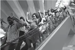  ?? REUTERS/SIEGFRIED MODOLA ?? Shoppers flee down an escalator after gunmen stormed the Westgate shopping mall in Nairobi on Saturday, killing more than 60 people.