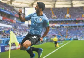  ?? Khaled Desouki / AFP / Getty Images ?? Luis Suarez muscled in the goal that beat Saudi Arabia and sent Uruguay to the second round of the World Cup.