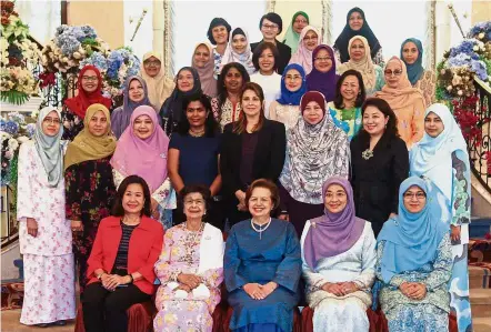  ??  ?? Strong team: Dr Siti Hasmah (sitting, second from left), Dr Zeti (sitting, centre) and members of Kasih Malaysia posing for a group photograph in Putrajaya.