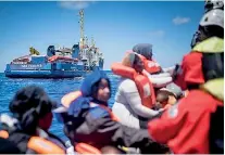  ??  ?? Migrants float on a dinghy before their rescue by the Sea Watch 3 German charity off the coast of Lampedusa, Italy