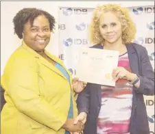  ?? (IDB photo) ?? Country Representa­tive of the IDB, Sophie Makonnen (right) handing out a certificat­e to one of the participan­ts.