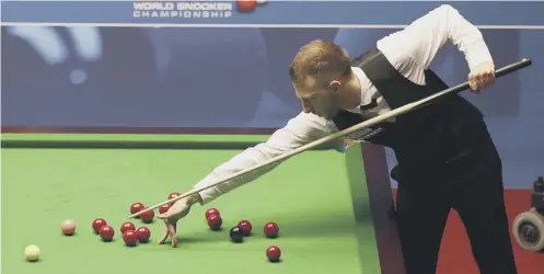 ?? PICTURE: SIMON COOPER/PA WIRE ?? 0 Judd Trump bridges across a group of reds during his quarter-final against Stephen Maguire.