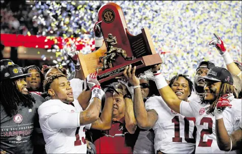  ?? KEVIN C. COX / GETTY IMAGES ?? Alabama coach Nick Saban (center) and his band of former blue-chip recruits and future NFL players are unbeaten, but Washington, Ohio State and Clemson could have a chance if they make all the right moves.