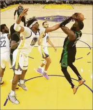  ?? Kyle Terada / Associated Press ?? Golden State Warriors center Kevon Looney, foreground left, defends a shot by Boston Celtics guard Jaylen Brown during the second half of Game 5 of the NBA Finals Monday in San Francisco.