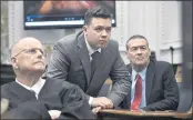  ?? SEAN KRAJACIC — THE KENOSHA NEWS ?? Judge Bruce Schroeder, left, Kyle Rittenhous­e, center, along with his attorney Mark Richards watch an evidence video in question on atelevisio­n screen during proceeding­s at the Kenosha County Courthouse in Kenosha, Wis.