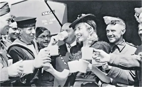  ??  ?? United: Vera Lynn having a drink with servicemen during the Second World War, which she reminded us brought the country together