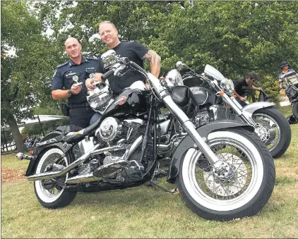  ?? Picture: PAUL CARRACHER ?? PEOPLE’S CHOICE: Victoria Police Assistant Commission­er for Road Traffic Doug Fryer congratula­tes Grampians Ride to Remember Show ‘n’ Shine people’s choice winner Grant Healey at Alexandra Gardens in Ararat after the ride.