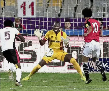  ?? — AP ?? Sealed: Mohamed Salah scoring Egypt’s winning goal against Uganda during the World Cup qualifying match at the Borg El Arab Stadium in Alexandria on Tuesday.