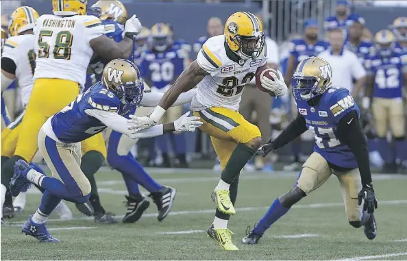  ?? KEVIN KING ?? Edmonton Eskimos running back LaDarius Perkins finds a crease between Winnipeg Blue Bombers defenders Bruce Johnson, left, and Roc Carmichael en route to a touchdown run during CFL exhibition play Thursday in Winnipeg. The teams played to a 38-38 tie.