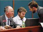  ??  ?? Rep. Allen Peake (left) confers with Rep. David Clark, who later presented his bill, as the Medical Cannabis Working Group meeting got underway Tuesday.