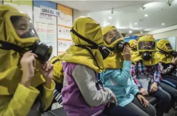  ?? LAM YIK FEI/THE NEW YORK TIMES FILE PHOTO ?? Students learn to use gas masks in case of chemical or biological attacks at a training centre in Seoul, South Korea.