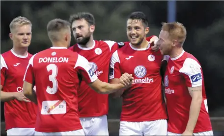  ??  ?? Seamus Sharkey celebrates with team-mates after scoring the equaliser for Rovers. Pics: Carl Brennan.