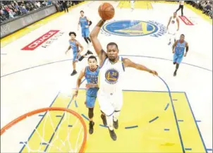  ?? NATHANIEL S BUTLER/NBAE/GETTY IMAGES / AFP ?? Kevin Durant of the Golden State Warriors scores against the Oklahoma City Thunder on Wednesday at Oracle Arena in Oakland, California.