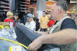  ?? JOE RAEDLE/GETTY IMAGES FILE ?? Chef and restaurate­ur Jose Andres, right, helps prepare a truck of relief supplies to be sent out from San Juan to hungry residents of Puerto Rico after Hurricane Maria.