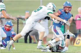  ?? [PHOTO BY BRYAN TERRY, THE OKLAHOMAN] ?? Blake Curtin of Oklahoma Christian School tries to get past Ty Tucker, left, and Trey Dorrell of Jones during Friday’s high school football game in Edmond.