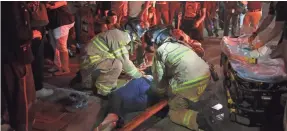  ?? ELIJAH NOUVELAGE/EPA-EFE ?? Emergency responders treat protester Wanda Cleveland late Saturday after she was struck by a Sacramento County Sheriff ’s Department vehicle after a rally south of the city. The patrol car left the scene.