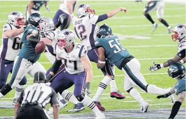  ?? AFP ?? The Patriots’ Tom Brady, No.12, is sacked by the Eagles’ Brandon Graham, No.55.