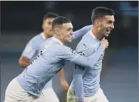  ?? PICTURE: PA ?? ALL SMILES: Manchester City’s Ferran Torres ( right) celebrates scoring his side’s third goal of the game with Phil Foden.