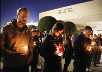  ?? TOM FOX — THE DALLAS MORNING NEWS FILE ?? Church and community members, including Matt Pacholczyk, left, and his wife, Faith Pacholczyk, stand outside West Freeway Church of Christ for a candleligh­t vigil in White Settlement, Texas.