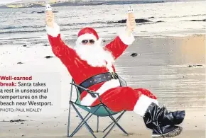  ?? PHOTO: PAUL MEALEY ?? Well-earned break:Santa takes a rest in unseasonal temperture­s on the beach near Westport.