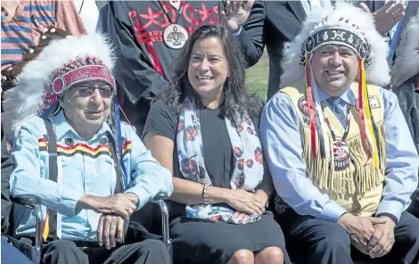  ?? ANDREW VAUGHAN/THE CANADIAN PRESS ?? Justice Minister Jody Wilson-Rayboud is flanked by Mi’kmaq Grand Chief Ben Sylliboy, left, and Morley Googoo, regional chief for Nova Scotia and Newfoundla­nd, in Wolfville, N.S. on Thursday.