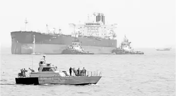  ?? — AFP photo ?? File photo of an Iranian military speedboat patrols the waters as a tanker prepares to dock at the oil facility in the Khark Island, Iran.