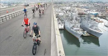  ??  ?? CALTRANS said a visual impact analysis is needed. One design concern is whether the 195-foot clearance could be retained for Navy ships and cargo traffic. Above, cyclists during the Bike the Bay ride in 2015.