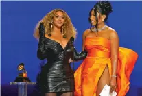  ?? CHRIS PIZZELLO/ASSOCIATED PRESS ?? Beyoncé, left, and Megan Thee Stallion accept the award for best rap song for ‘Savage’ at the 63rd annual Grammy Awards on Sunday at the Los Angeles Convention Center.