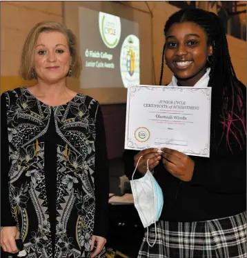  ??  ?? History award winner Ohemaah Wiredu receives her certificat­e for History from Ms McEnri at the Ó Fiaich College Junior Cycle Awards Ceremony.