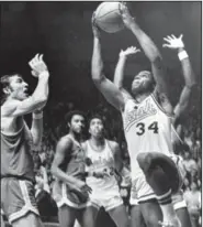  ?? (AP file photo) ?? Notre Dame’s Austin Carr (34), here playing against UCLA in 1971, set himself apart in an era when prolific scorers dominated college basketball. He scored a still-standing NCAA Tournament record of 61 points against Ohio the year before.