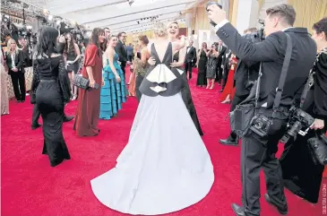  ??  ?? Greta Gerwig embraces Saoirse Ronan at the 92nd Academy Awards last year.