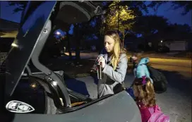  ?? GODOFREDO VASQUEZ / HOUSTON CHRONICLE ?? Sarah Enamorado and her daughters Sophie, 11, and Elizabeth, 4, pack up the car for the ride to school Wednesday in Katy. Since Harvey, Enamorado takes Sophie to school earlier than usual. Sophie can’t ride the bus because the school district cut the...