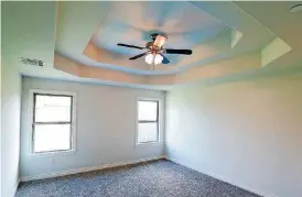  ??  ?? The trayed ceiling is a striking feature of a bedroom at 1417 SW 96.