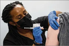  ?? ASSOCIATED PRESS ?? Cole Smith receives a Moderna variant vaccine at Emory University in Decatur, Georgia. Smith, who received Moderna’s original vaccine a year ago in a study, said returning wasn’t a tough decision: “Why not volunteer and help people?”