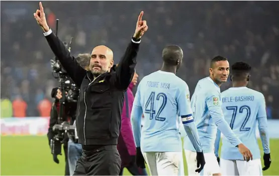  ??  ?? In a league of their own: Manchester City manager Pep Guardiola acknowledg­ing the crowd after the League Cup win over Leicester at the King Power Stadium on Dec 19. — AP