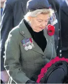  ??  ?? MOVING Anne Blair lays wreath for husband
