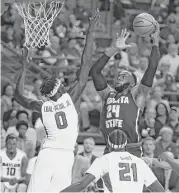  ?? Rod Aydelotte / Waco Tribune-Herald ?? Wichita State center Shaquille Morris, right, goes strong to the basket over Baylor forward Jo LualAcuil Jr. in the first half Saturday.