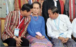  ?? — AFP ?? Myanmar vice- president Henry Van Thio ( left), Myanmar’s foreign minister and state counsellor Aung San Suu Kyi and Myanmar President Win Myint speak after the third session of the Union Peace Conference in Naypyidaw on Wednesday. Myanmar military...