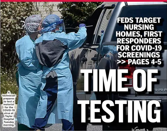  ?? PETE BANNAN - MEDIANEWS GROUP ?? A technician prepares to test a motorist for the COVID-19 virus at Taylor Hospital Tuesday morning.