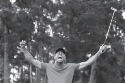  ??  ?? TIGER Woods of the U.S. celebrates on the 18th hole after winning the 2019 Masters. File Photo. Lucy Nicholson, Reuters