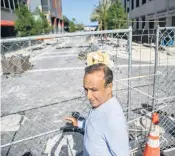  ?? MATIAS J. OCNER mocner@miamiheral­d.com ?? Moishe Mana stands at a fenced-off portion of Flagler Street that’s under reconstruc­tion. The $30 million city project, which Mana pushed for, will convert Flagler into an elegant cobbleston­ed street.